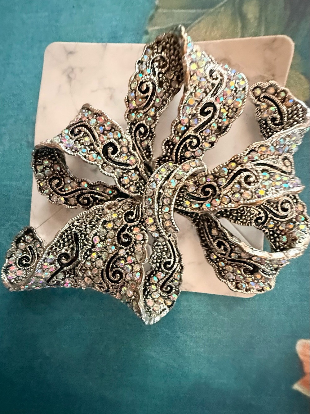 Crystal-Embellished Silver Floral Brooch.